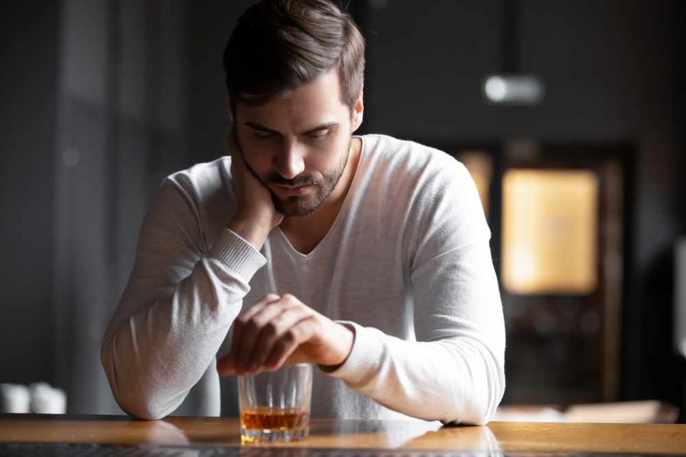 is alcohol a downer or upper