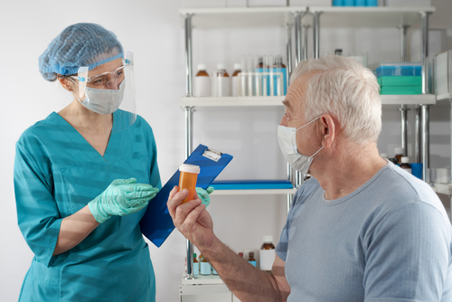 man talking to nurse about pills