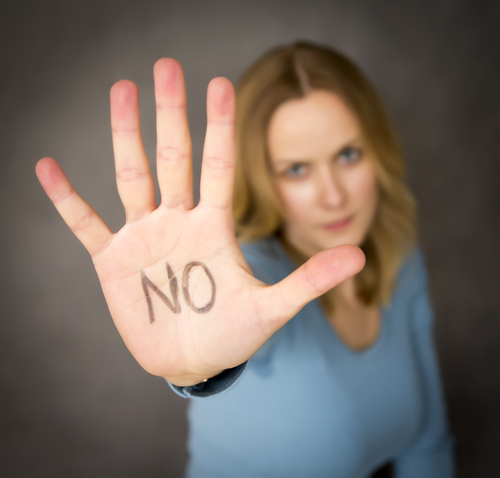 woman putting hand up with no written on hand