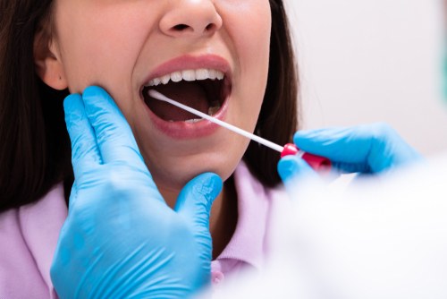 woman receiving a mouth swab test