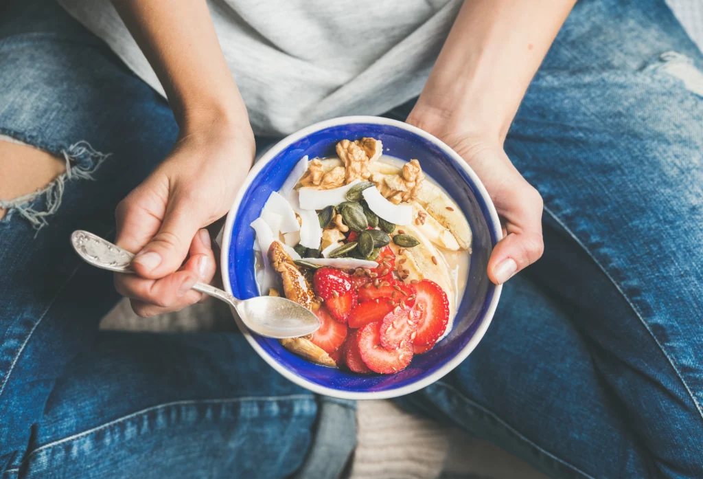 Person eating a healthy acai bowl