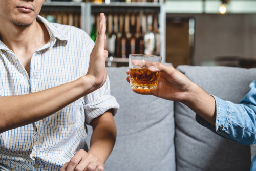 man refusing alcohol to quit drinking cold turkey