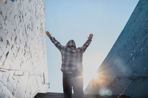 man celebrating at the top of stairs