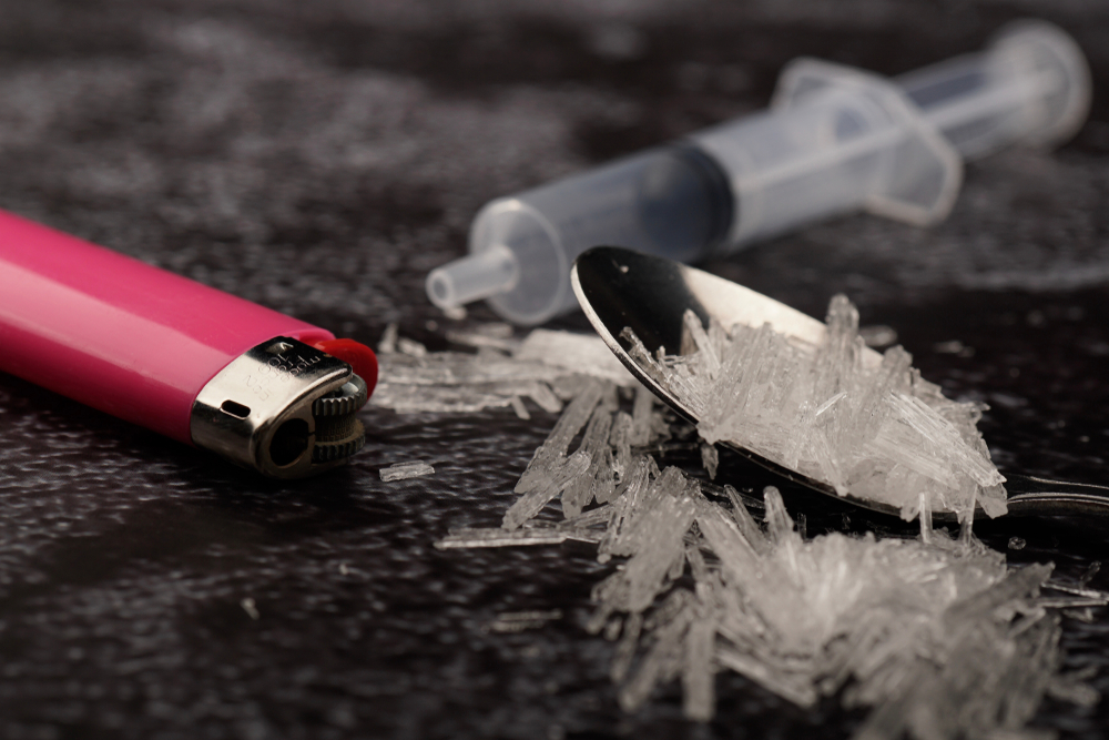 methamphetamine on floor with lighter and syringe