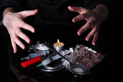 various forms of meth on table with hands over it
