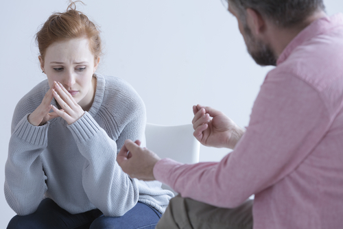 woman getting help for addiction from man
