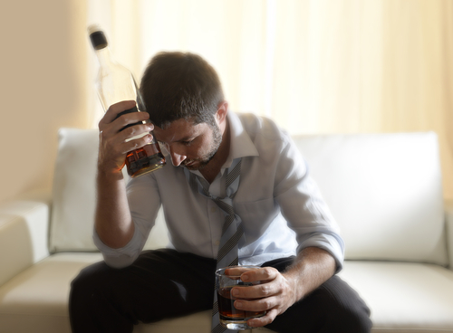 man holding alcohol bottles