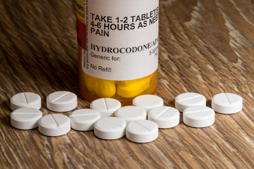 hydrocodone pills next to pill bottle