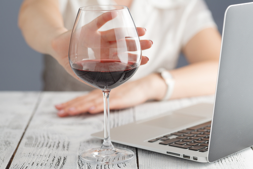 woman pushing away glass of wine