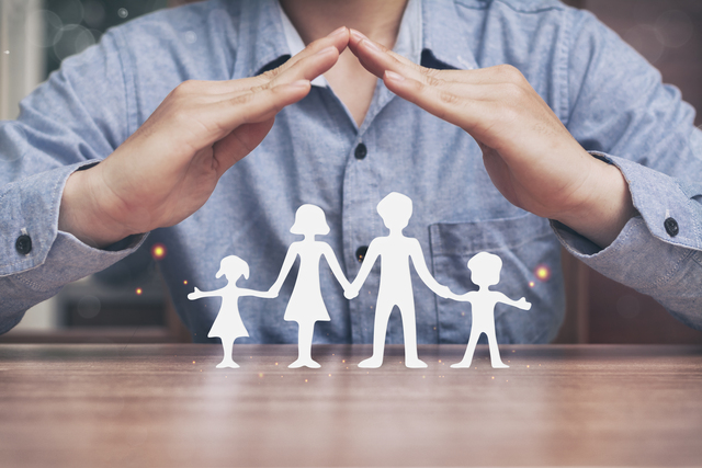 small protecting hands over paper family family protection and stay home or working at home with care concept